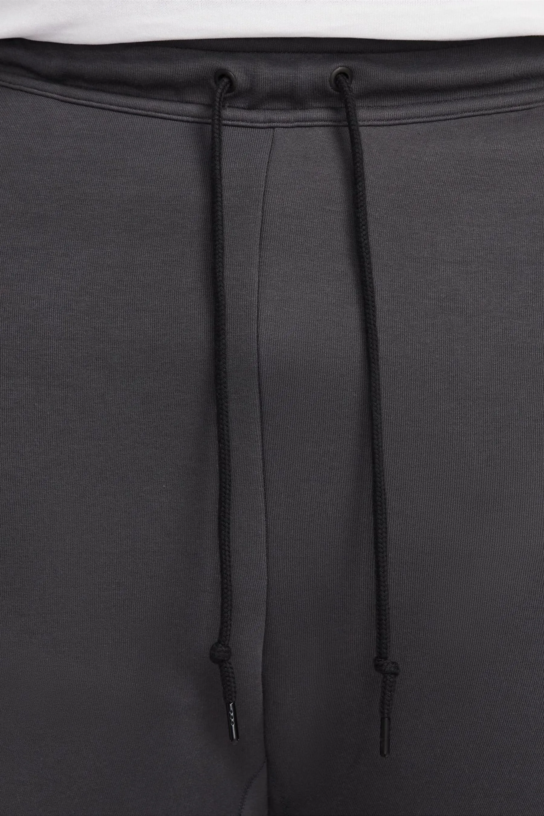 Nike - Pantaloni da jogging in tessuto tecnico e pile